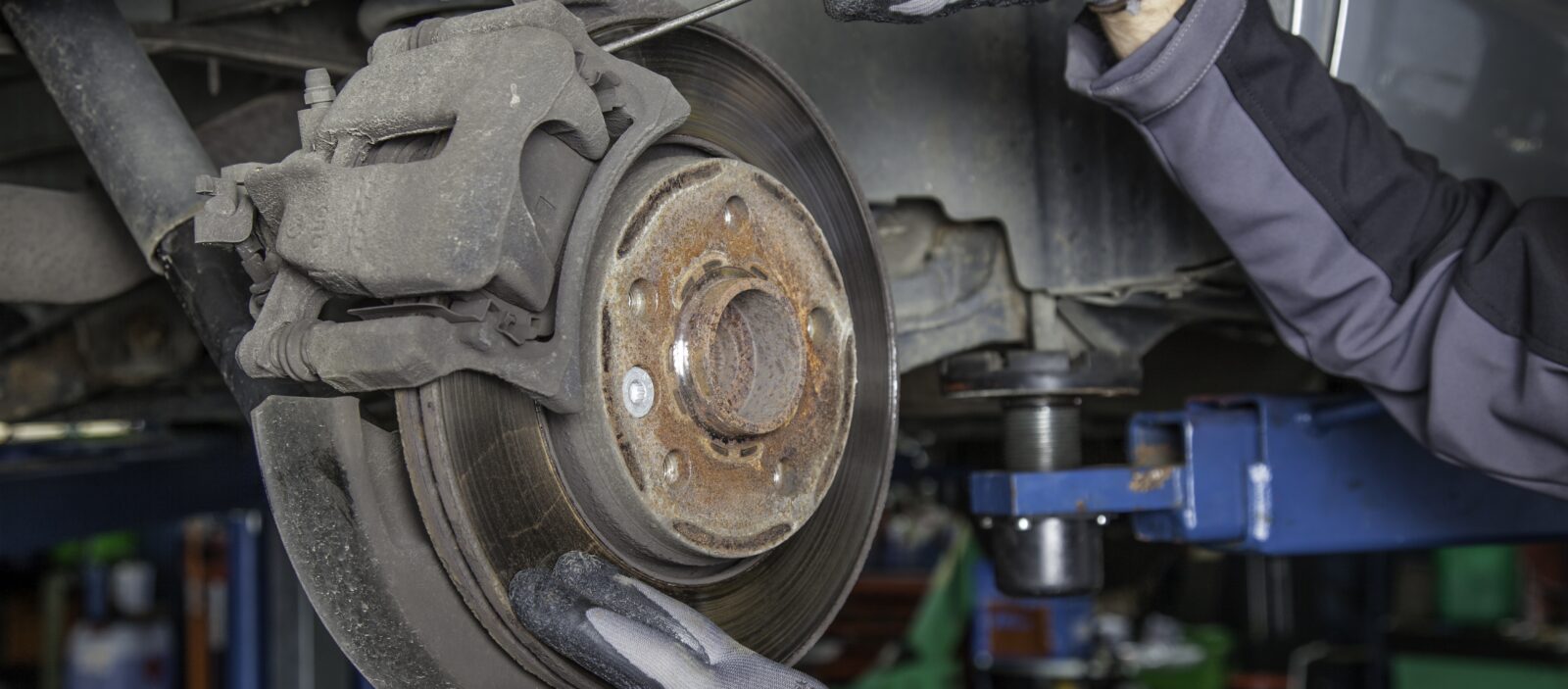 Toybox Automotive mechanic fixing brakes.
